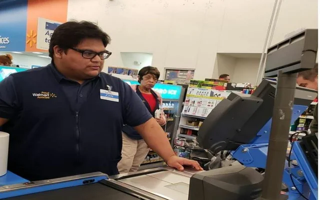 Teenage cashier thrift for the Institute pays the grocery bill to the buyer at Texas Walmart